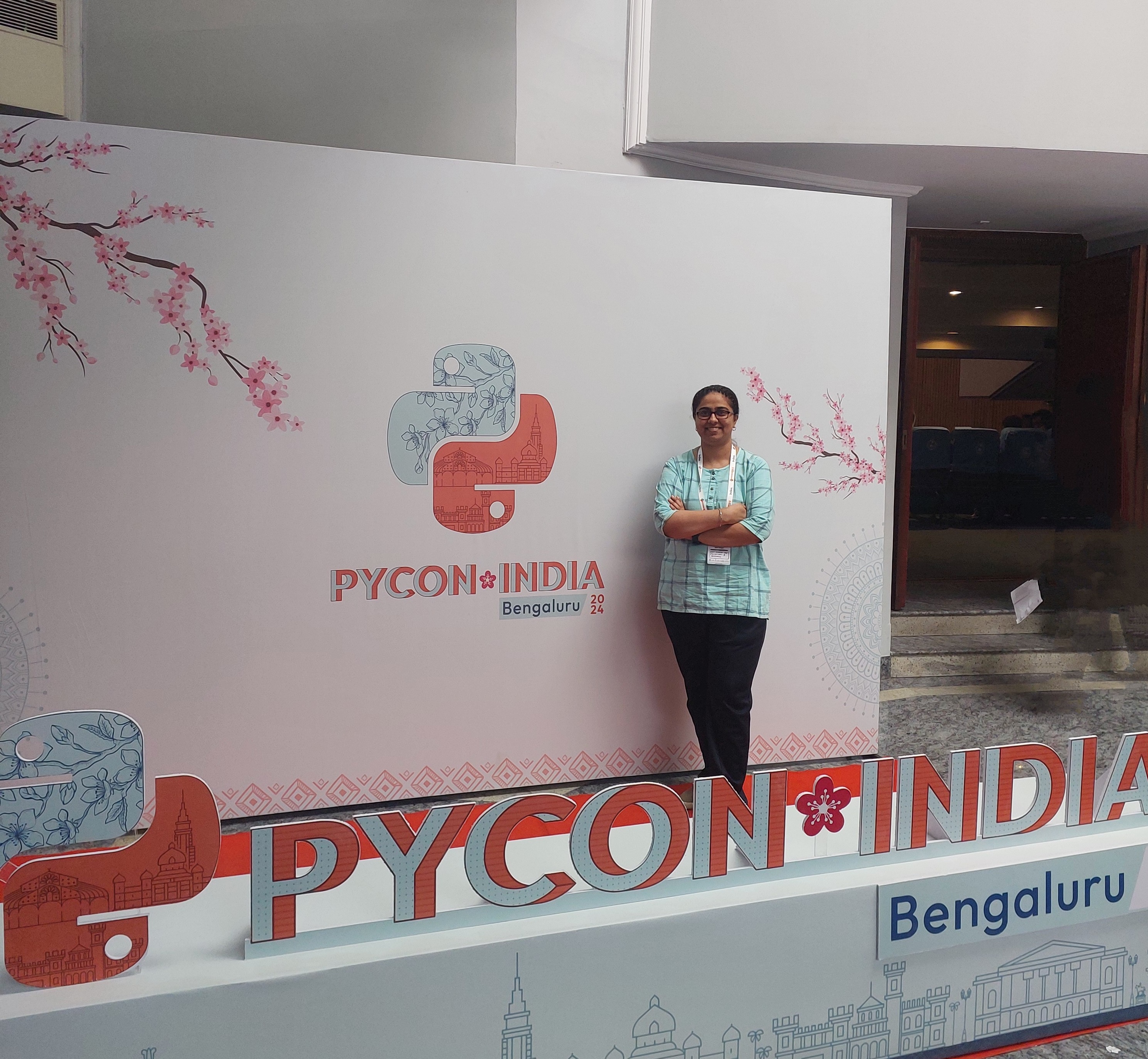 Jyoti Bhogal with the PyCon India 2024 Banner